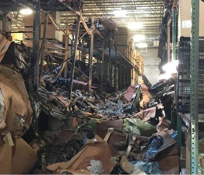 Fire damaged debris in large warehouse.