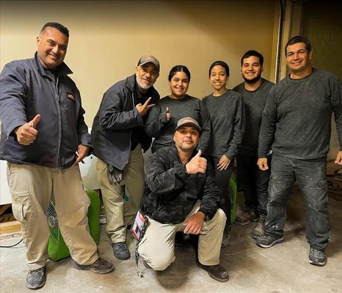 7 SERVPRO water damage restoration technicians posing with smiles for a picture