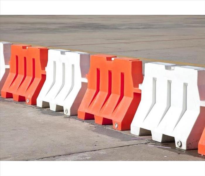 Red and white plastic barriers blocking the road